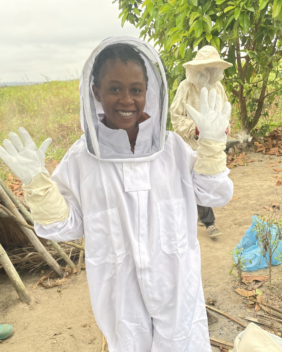 Our team in protective clothing at the hives, Kongo Central